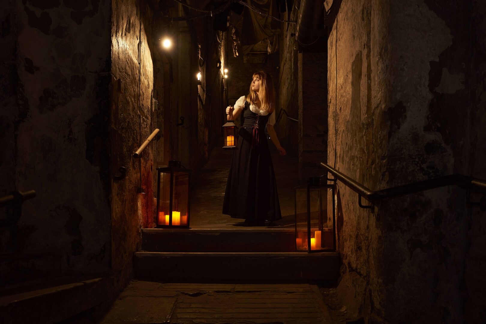 Real Mary Kings Close Tour guide with a Lantern at the top of the close