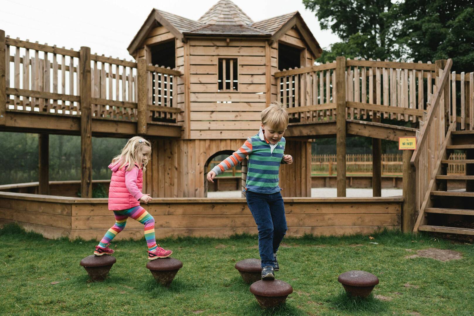 Two young children playing in MiniMaze at Fort Douglas - located at Dalkeith Country Park, Dalkeith Country Park