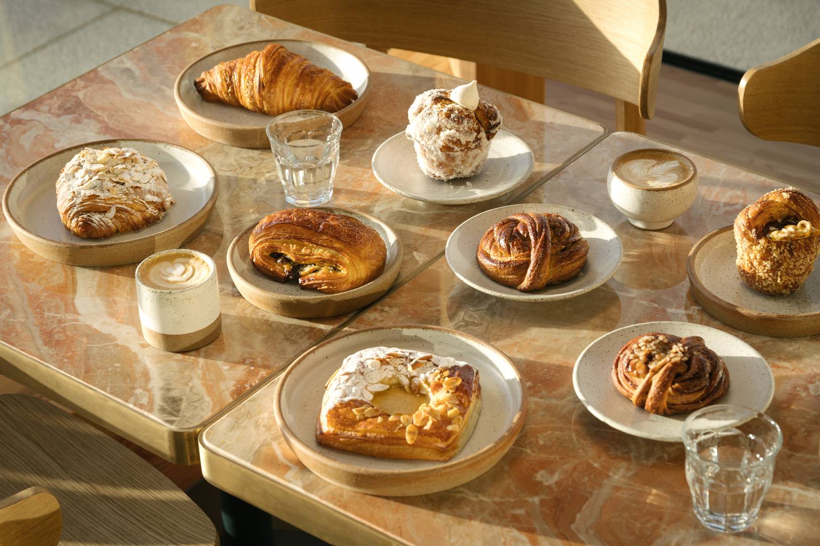 A table abundantly full of crafted pastries and masterful coffee served in our own crafted pottery,© Patina Edinburgh